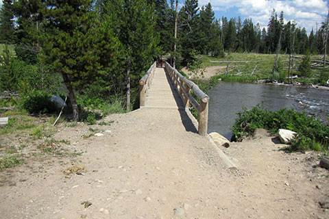 Bridge over the String Lake Outlet leading to the trailhead