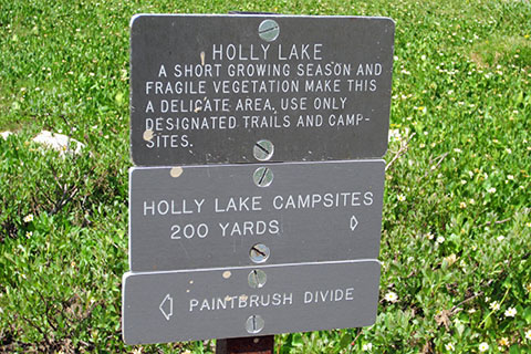 Holly Lake signs for minimum impact use, campsite direction, and the divide