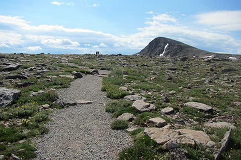 Trail aiming toward Hallett Peak standing over Flattop Mountain