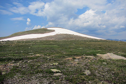 A snowy knob of 12,277 feet to the west of the trail