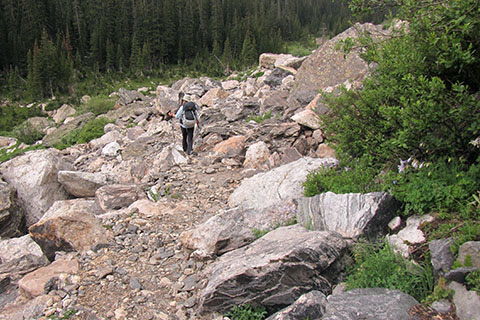 hiker crossing a boulderfield