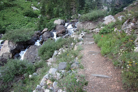 The trail switchbacks near the creek