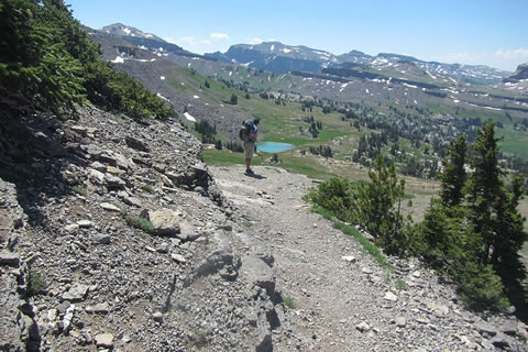 Hiker on the north side of Sunset Lake as he climbs toward Hurricane Pass