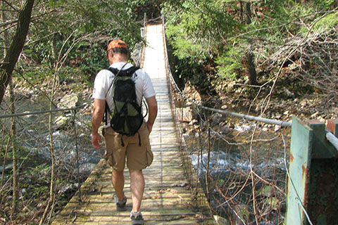 Crossing Cane Creek on a suspension bridge